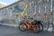 Berlin / Germany - 30 June 2018: Orange dock-less bikes for hire at East Side Gallery, a 1316Â m long remnant of theÂ Berlin Wall